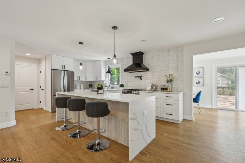 FULLY RENOVATED COMMUTERS DREAM HOME! Steps away from Allendale downtown and direct train to NYC! This beautiful property combines modern luxury with classic charm, offering an exceptional living experience. With modern fixtures, elegant hardwood flooring, and tasteful design elements throughout, this dream home create a warm and inviting atmosphere.The chef's kitchen boasts a 10 ft center island, breakfast bar, and top-of-the-line appliances. The open layout seamlessly connects the kitchen and living room, creating a perfect space for entertaining and daily living.The dining room is sun drenched with oversized windows looking at the HUGE backyard. The first-floor master suite allows for generational living, featuring a spacious walk-in closet and a luxurious ensuite bathroom. While the second floor offers two oversized bedrooms and a full bath, perfect for guests or a home office. In addition to the large basement recreation area, the walk-out basement includes an additional egress bedroom with its own full bathroom, ideal for guests or as an in-law suite. Situated in a peaceful neighborhood, this home offers easy access to excellent schools, shopping, dining, and is close to nearby Crestwood Lake & Park and Celery Farm. Looks are deceiving in this oversized cape! MUST SEE! Don't miss the opportunity to call this exceptional home yours!