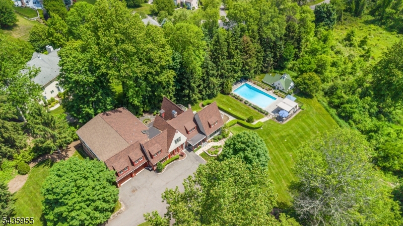ONE-OF-A-KIND PRIVATE ESTATE IN MORRISTOWN SEAMLESSLY BLENDS HISTORICAL CHARM WITH LUXURY LIVING! Once a carriage house/stable, 43 Knox Hill is perched on a pastoral ridge just minutes from vibrant Morristown Green but a world away w/ 2+ acres of exquisitely landscaped hilltop lawn w/ uncompromised eastern views, heated pool w/ the ultimate outdoor kitchen, nautical-inspired Pool House w/ exercise room, full bath & outdoor shower & European-style gardens w/ old stone paths & fountain. Roots of this historic home are evident in its timber-frame exterior, exposed old brick & ceiling beams, but expansions & a loving touch over the years have resulted in a magical 5 Bed/5.1 Bath home w/ every modern comfort & convenience. Expansive Family Room w/ walls of windows & wet bar & the dreamy Eat-in Kitchen capitalize on stunning vistas & open to sprawling multi-level deck. Storybook details in Kitchen like exposed brick fireplace & wood beams are enhanced by designer appliances including a wine fridge, warming drawer & pot filler. Open Living/Dining Room centers around a fireplace with built-in seating & cabinetry, making this a favorite winter dining & entertaining space. 1st Level Bedroom, Full Bath, Office & huge attached Garage make everyday living easy. 2 staircases lead to 2nd Level, offering incredible versatility with 3.1 baths, giant Rec Room w/ built-ins, large Bonus Room & 4 Bedrooms inc. Primary Suite w/ stunning luxury bath. Too many features to mention. Simply a must-see!