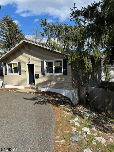 Convenient location, walk to stores and post office - needs TLC update your way!  Offers off street parking, h/w floors, fireplace and full walkout basement ready for finishing! One finished room was used as a library- Ample back yard with privacy fence!