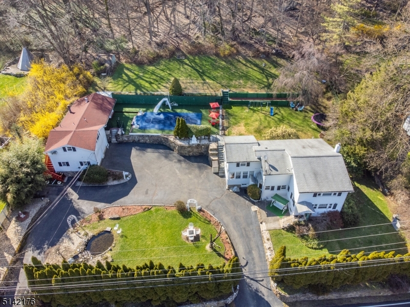 REMARKSPUBLIC Rare find!! TWO HOMES nestled on beautiful park-like property. Flowing, practical layout great for entertaining. Large living room welcomes you into the "Main House? which sits prominently to the right. Formal dining w/built-ins & walkout to back deck. Updated, EiK features granite countertop, center island & SS appliances. Stunning & bright sunroom/den. HW floors throughout. Upstairs, 3 bdrms plus an office/sitting room & full bath. Full finished BSMT IN-LAW SUITE w/sep entrance, kitchen, family room, office & full bath. Laundry & storage. Beautiful backyard oasis with deck, in ground pool, bath/shower & large lawn. Completely fenced in. Over 2.5 acres - truly a Staycation! Privacy- backed against wooded landscape & arborvitaes in front. Lovely fish pond. Lots of sun. Perfect for Entertaining & Relaxation! The Pool house, which is the 2nd Home on property sits to the left " offers even more living & potential income- 8x8 kitchen, 19x17 living / dining, 20x20 bedroom w/walk-in closet & 1.5 baths. 2 Car Detached Garage. Tons of parking- circular driveway, enough space for all your guests. Walk to NYC Direct train station. Easy access to major highways & TOP schools. Choose to stroll through bustling DWTN Denville w/its many restaurants & shops, historical Mt Tabor w/its colorful Victorians & Tabernacle events or Morristown Green. Great location, amazing opportunity & tons of value.