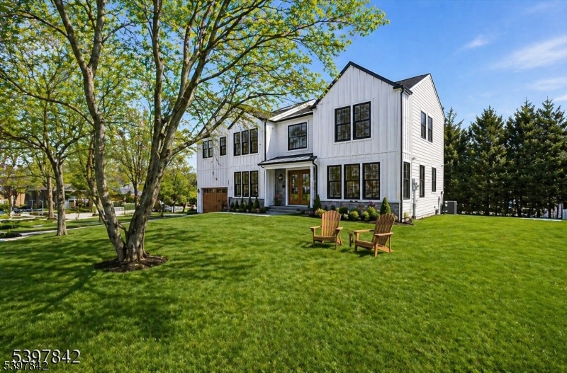 Newly rebuilt and expanded with four beautifully finished levels, this exceptional home combines expansive living spaces with modern, on-trend finishes designed for today's lifestyle. Backing to town land and perfectly tucked away on a quiet cul-de-sac just steps from schools, sidewalks to town, and everything this vibrant community offers, the location is simply unbeatable. Featuring 6 spacious bedrooms and 6.5 thoughtfully designed baths, this residence delivers remarkable space and flexibility for everyone. Sunlight pours through abundant windows, enhanced by soaring 9-foot ceilings and impeccable craftsmanship throughout. Custom millwork and high-end finishes reflect a true commitment to quality. A first-floor en suite provides ideal accommodations for guests. At the heart of the home is a chef's kitchen, equipped with top-tier designer Thermador appliances and an oversized island that invites gathering and connection. Entertain effortlessly in the formal dining room with its chic butler's pantry. The primary suite is a serene retreat, boasting a spa-like bath with double shower, dual vanities, and his-and-hers walk-in closet space. 5 additional generously sized bedrooms and ample baths ensure comfort for all. The finished walk-out basement offers exceptional flex space, a full bath, and access to a private, level backyard with a patio and tranquil wooded views.  With easy NYC access, an unbeatable community, this home truly offers the best of inspired luxury living.