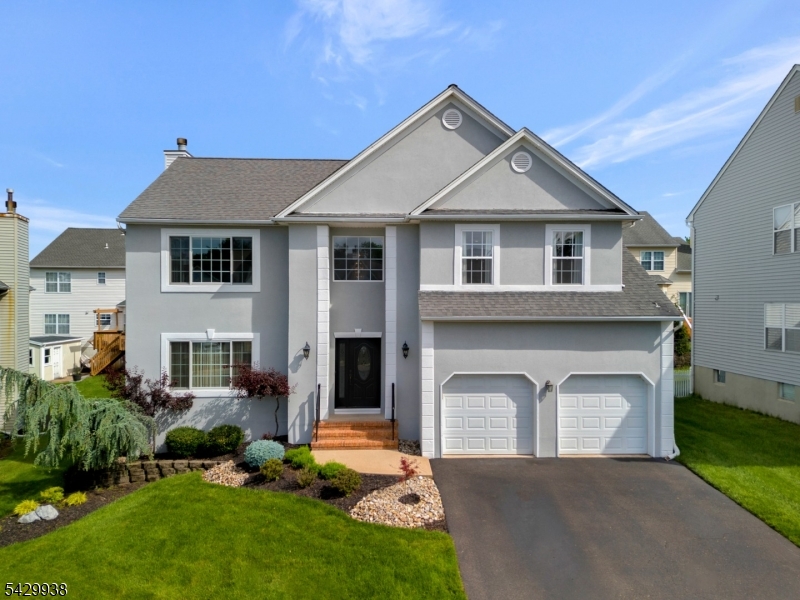 This distinctive Gabrielle Model is perched high on a quiet cul-de-sac with a coveted south-facing setting, this stunning colonial offers timeless elegance, exceptional updates, and refined living throughout. A dramatic 2-story entry welcomes you with classic wainscoting and crown molding, setting the tone for the sophisticated interiors beyond. The sun-filled living room with hardwood floors and French doors opens to a warm and inviting family room featuring a wood-burning fireplace, crown moldings, recessed lighting, and sliding doors to the outdoors perfect for seamless entertainment. The beautifully renovated eat-in kitchen is designed to impress, showcasing granite countertops, a center island, a Wolf range, a custom counter bar with a beverage refrigerator, and abundant space for gathering. A formal dining room with hardwood floors and elegant moldings is perfect for entertaining, while an updated powder room completes the main level. Upstairs, hardwood flooring flows throughout. The luxurious primary suite, through double doors, is a true retreat with recessed lighting, crown molding, a custom outfitted walk-in closet, and a beautifully updated bath with a glass-enclosed shower, jetted tub, and radiant heated floors. Three additional spacious bedrooms and an updated full bath complete the second level. The finished daylight basement expands the home's living and entertaining possibilities with generous recreation space, abundant storage, and a dedicated laundry area.