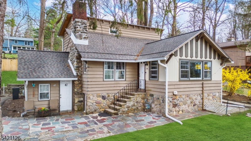 Welcome to this 3-bedroom custom home in the highly sought-after Lake Mohawk community! Nestled on a private wooded lot, this inviting property blends comfort, charm, and natural surroundings. Inside, you'll find high ceilings, hardwood floors and plenty of natural light throughout. The living room features a beautiful stone fireplace, creating a warm and welcoming vibe, plus a versatile bonus room offering endless possibilities   perfect for a home office or guest space. Recent updates include a new roof, repointed chimney, new 2nd floor windows, new refrigerator and conversion to gas heating. Enjoy the patio - perfect for relaxing or hosting gatherings in a serene, wooded setting. Ideally located close to shopping, transportation, restaurants, and park, this home also offers access to all that Lake Mohawk is known for: scenic views, community amenities, and a tranquil lifestyle. A truly special place to call home.