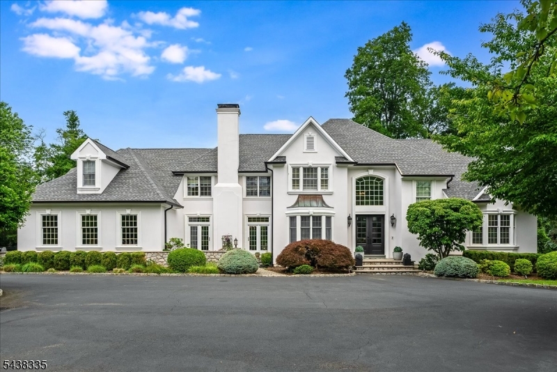 From the moment you arrive, this exceptional custom estate captivates with its striking curb appeal and expansive three-level design. Set on beautifully landscaped, level grounds in one of Warren's most desirable neighborhoods, the home showcases sun-drenched interiors enhanced by thoughtful architectural details throughout.A dramatic two-story foyer welcomes you inside, where a private office and a generously sized first-floor bedroom suite provide flexibility and convenience. The impressive living room features a soaring two-story wall of windows, while the inviting great room flows seamlessly into the spacious, updated custom kitchen. Designed for both everyday living and entertaining, the kitchen boasts premium finishes and a charming octagonal, window-lined breakfast area overlooking the grounds.The luxurious primary suite offers a private sitting room with fireplace and a spectacular dressing suite featuring custom-fitted walk-in closets, room-sized wardrobes, an office and a spa-inspired bath. Three additional second-floor bedrooms provide ample accommodations, including two with en-suite baths.The fully finished lower level expands the living space with a recreation room, wine cellar, private office, two additional bedrooms, and one-and-a-half baths. Exceptional storage is found throughout every level of the home.Completing the property is a Belgian block-lined driveway providing elegant and convenient access to the main entrance.