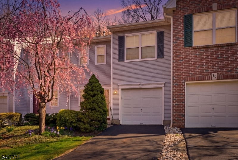 Beautifully maintained townhome in the desirable Pond Hollow community offering 2 bedrooms and 2.5 bathrooms. This home features a bright and functional layout with spacious living areas, abundant natural light, high ceilings, and generous room sizes throughout. The kitchen provides ample cabinet and counter space and opens seamlessly to the dining and living areas, creating an ideal flow for both everyday living and entertaining. Sliding glass doors off the kitchen lead to a private patio, perfect for outdoor enjoyment. The living room features high ceilings and a gas fireplace. The second level includes a primary bedroom with an en-suite bathroom and walk-in closet, a second bedroom, an additional full bathroom, and a laundry room. Additional highlights include a first-floor powder room, attached one-car garage, and ample storage throughout. Conveniently located near shopping, dining, parks, and major highways, this move-in-ready home offers low-maintenance living in a well-established community.