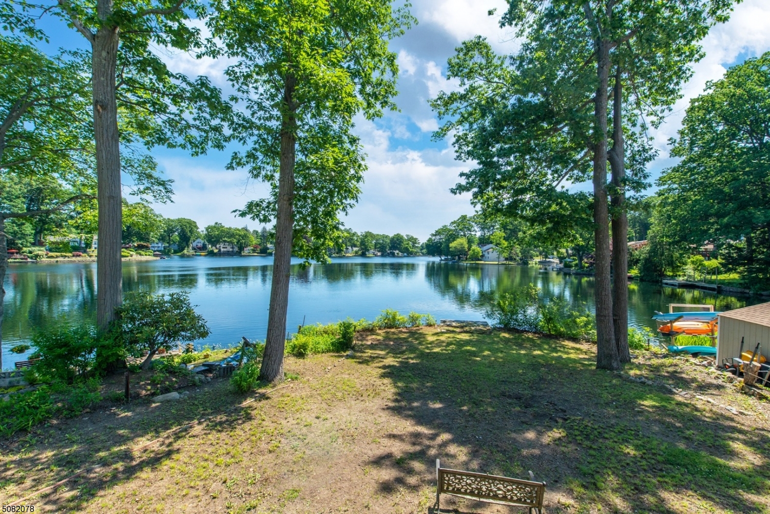 Start enjoying Lakefront living in Rainbow Lakes! Walk right in & instantly be impressed with the lake views! Located on the main lake this 2BR, 1BTH home offers views from every corner. Functional galley kitchen, bright dining & sitting area, large LR features a gorgeous WB stone fireplace, tons of windows & sliders to the oversized deck. Convenient 1st floor bdrm, full bath & laundry closet complete the 1st level. Gorgeous HW floors! The 2nd level offers a large bdrm w/tons of windows! Bonus bsmt has a ton of potential! Tons of storage space. Additional features include central air, gas heat, upgraded electric, & off street parking. Newer roof, siding, & windows! Be a part of this wonderful community with so many recreational activities to enjoy! Gorgeous Lake views right in your backyard. Sunrise views.