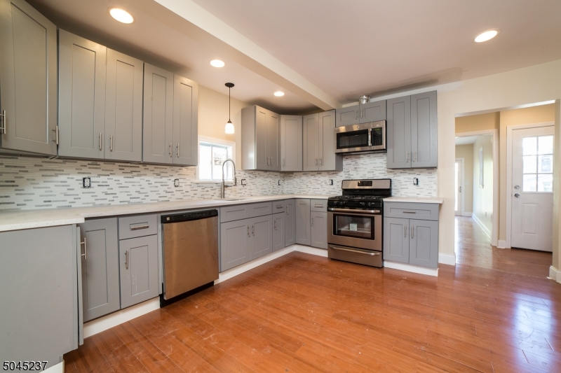 Beautifully updated 3 bedroom 1.5 bath Colonial close to shopping, transit, and restaurants. Upgrades include new in 2017 Roof, Siding, Electric, Plumbing, Gleaming bamboo flooring throughout, quartz countertops, stainless steel appliances, central air. 1 car detached garage and large back deck for entertaining. First floor bonus office/den that can be used as a 4th bedroom.