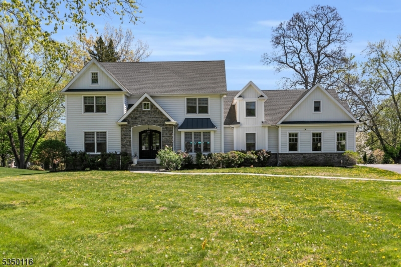 This stunning custom-built 5-bedroom home features a modern open floor plan, blending style and functionality perfect for both everyday living and grand entertaining. Step inside to discover hardwood flooring throughout, adding warmth and elegance to every corner of the home. Elevating the kitchen into a chef's paradise are the Carrera marble countertops, two islands, Italian cooking appliances and custom cabinetry showcasing exceptional craftsmanship. The living room is a showstopper, boasting high ceilings and a cozy gas fireplace, creating an inviting space for relaxation and gatherings. Adjacent, the dining room sets the stage for memorable dinners. The primary bedroom, conveniently located on the first floor, offers a serene retreat with a full bath with marble countertops, a soaking tub and spa shower as well as a walk-in closet. An additional en-suite first-floor bedroom provides flexibility for guests or a home office. A powder room, laundry room, and pantry complete this level. Upstairs are 3 spacious bedrooms, 2 sharing a well-appointed Jack & Jill bath and another full bathroom for added convenience. The enormous rec room is a standout, offering endless possibilities. The unfinished basement, pre-plumbed for a bath, awaits your person touch, ideal for a gym, media room, or extra living space. This truly remarkable home blends modern design, premium finishes, and thoughtful functionality into one irresistible package.