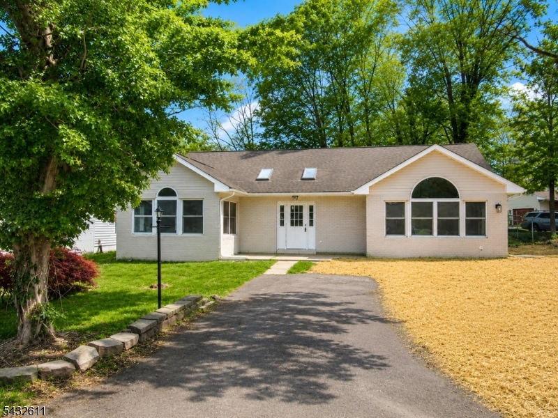 Welcome to this recently upgraded throughout and new septic system. This sun-filled ranch-style home located Lake Hopatcong offering a spacious 1,549 square feet of one-floor living and endless potential. As you enter through the front door, you're greeted with a rectangular foyer that opens into an L-shaped living area, naturally lit by oversized windows and a central skylight which brightens the entire space. To the right of the entry, the kitchen features vaulted ceilings, another skylight, and a generous casual seating area ideal for gatherings or a relaxed everyday living. A large rear deck is conveniently located just off the kitchen, providing a great spot for outdoor dining or weekend lounging. The layout includes two bedrooms, including a primary suite with a private bath (shower, vanity, and toilet). The second bedroom is a full hall bath with a tub/shower combo. While the backyard will need a full refresh, the home's structure and natural flow provide a solid foundation for transformation. Enjoy easy access to both Brights Cove and Prospect Point Marinas, making this an ideal location for boating enthusiasts or weekend lake escapes. Home inspection is for informational purposes only.