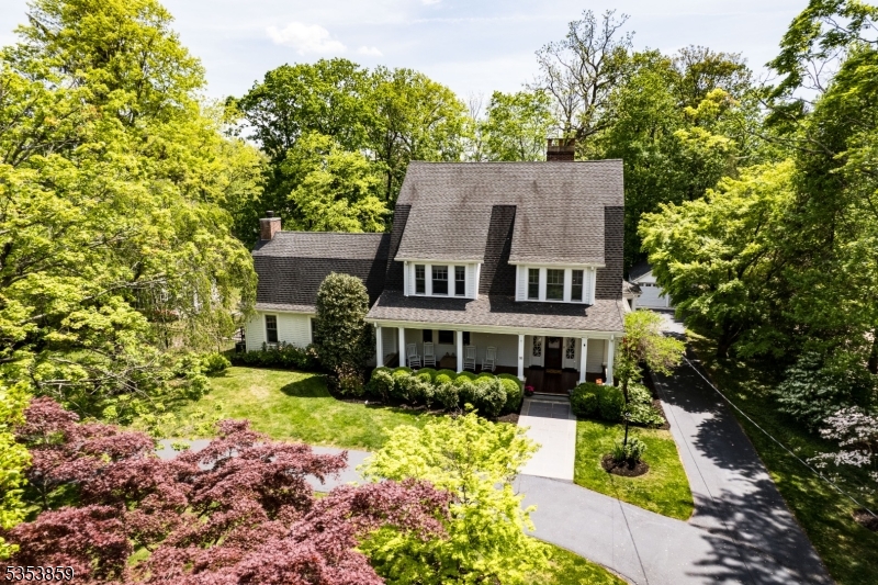 Vintage 1908 Colonial completely renovated for today's lifestyle while maintaining the grace of yesteryear.  High Ceilings beautiful moldings and hardwood floors throughout with oversized windows. Country setting yet just a few blocks  to town, train and schools. This 6 bedroom 3 1/2 bath  Dutch Colonial has 4 levels of living space on over an acre of property with mature beautiful trees and professional landscaping.  An new inground gunite heated pool with hot tub was added in 2020 by the current owner.  Also a greenhouse was added and a large 3 season porch with floor to ceiling fireplace.  There are wood burning fireplaces in the family room and 3 season porch and a gas fireplace in the kitchen.