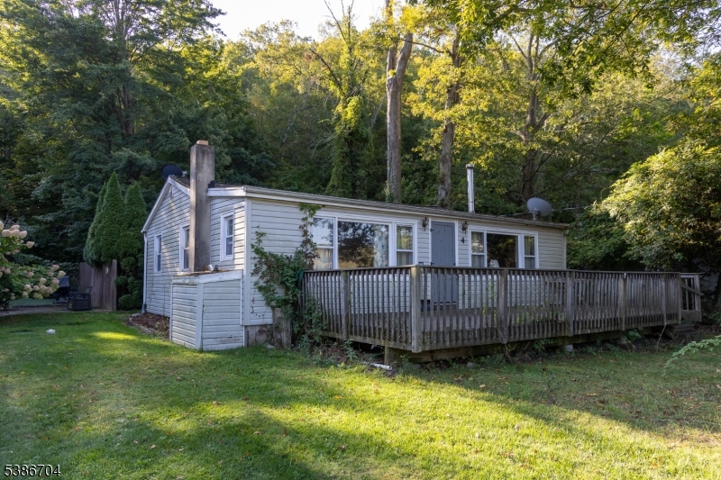 Charming Ranch-Style Home with Lake Views! Welcome to your cozy retreat. This delightful ranch offers 2 bedrooms and 1 bathroom. As you step inside, you'll be greeted by hardwood floors that flow through out the living areas, adding warmth and character. This inviting layout features a spacious living room that connects to the dining area creating an ideal area for everyone to gather. Living room has a wood burning stove, perfect for gathering around in the winter. The kitchen includes a skylight for extra natural lighting, and is easily accusable from the driveway. Located in a tranquil setting, this home offers a perfect blend of comfort and nature. One of the stand out features of this property are the stunning views of Kittatinny Lake right from your own front porch. This home is walking distance from the lake, basketball court, playground, and clubhouse. Short drive to restaurants, Appalachian hiking trails, and Sunrise Mountain. Monthly HOA fee's. Oven portion of the stove does not work, buyer accepts the oven as is.
