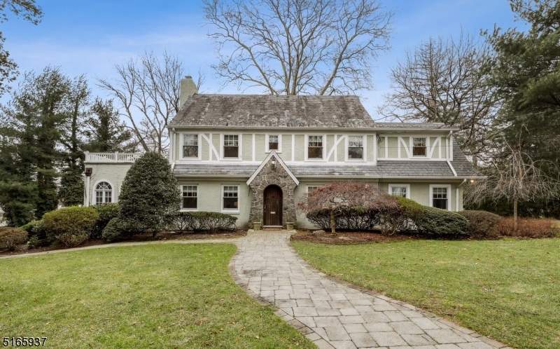 Welcome to this beautiful 4 BR, 5 full and 2 half bath center hall Colonial with stucco exterior, slate roof, high ceilings and gleaming HWD floors. As you enter the home, you are greeted by a lovely foyer that leads to a large living room, featuring front and rear windows that provide generous natural light and a wood burning fireplace. The dining room, with a corner built-in cabinet, offers a warm and inviting atmosphere. The huge wonderful family room boasts three walls of gorgeous windows and a wood burning fireplace. The eat-in kitchen offers great views of the patio and backyard and is equipped with SS appliances and white cabinets w/granite countertops. A terrific office and fabulous powder room complete the first level. The second level offers three en-suite bedrooms with generous walk-in closets and updated bathrooms. The primary bedroom has access to a large balcony, offering a peaceful retreat for the owners. The third floor features an additional bedroom, full bathroom and cedar closet. The expansive basement houses a large rec room, powder room, office w/ensuite full bath, laundry room, plentiful storage and access to the heated 2-car garage. New boiler (2023), water heater (2022), two dishwashers (2022), refrigerator (2021), whole house generator (2013) and mostly new windows (2009.) Top-rated Millburn schools, shopping, restaurants, Short Hills train station and easy access to many highways await the next homeowners.