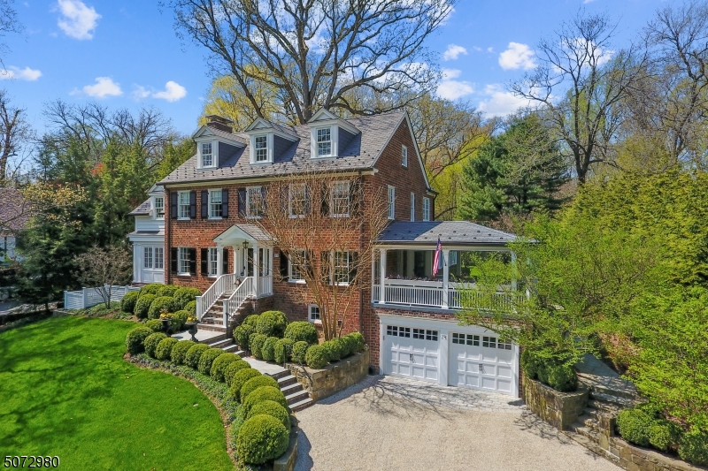 One of the prettiest homes in Summit! This authentic 1925 brick Georgian Colonial has been fully renovated and meticulously maintained. It offers the unparalleled interior flow that only a center-hall provides, stunning green views from every window, and a lush, sweeping lot where privacy abounds. An easy-living home where social spaces connect beautifully with each other, as well as the outdoors, and private spaces that become personal retreats. 74 Essex marries timeless elegance with today's modern amenities. A house that makes everyone feel right at home. One of the many spectacular features of this home is the beautiful .837 acres* of manicured outdoor gardens. The rolling green lawns offer a private, parklike setting reflecting the home's majestic curb appeal and unique charm.