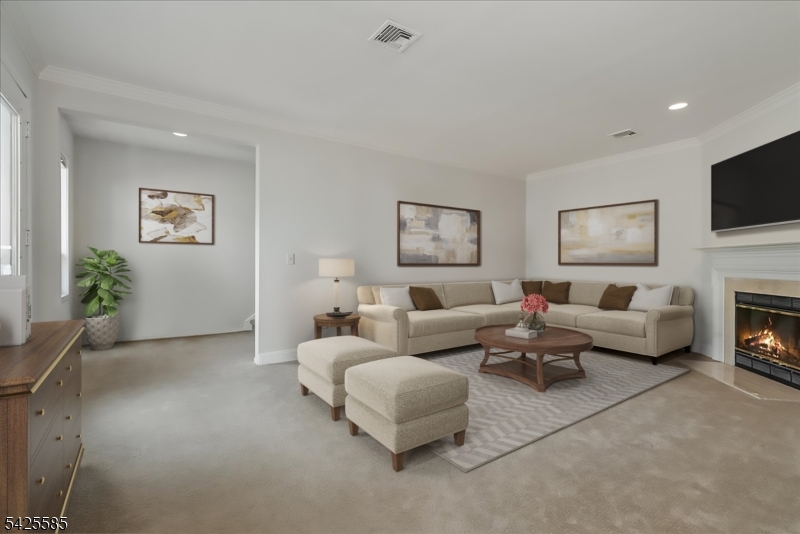 Situated in the heart of downtown Morristown, this updated townhouse offers a seamless blend of sophistication and convenience of urban living. Just moments from the Midtown Direct train to New York City, and surrounded by Morristown's acclaimed dining, boutique shopping, and cultural attractions, the location is simply unparalleled.This elegant 3-bedroom, 2 full bath residence showcases a thoughtfully designed open-concept layout, where a renovated kitchen with premium finishes, custom cabinetry, and quality appliances flows effortlessly into the dining area and an inviting living room anchored by a fireplace, creating an ideal setting for both intimate gatherings and stylish entertaining. Recent mechanical upgrades, including HVAC and central air (2023), ensure modern comfort, efficiency, and peace of mind.The primary suite serves as a tranquil sanctuary, complete with a full bath and a generous walk-in closet and laundry. The upper level offers two additional bedrooms, a full bath, and a versatile den, while a striking sunlit turret room provides a distinctive architectural focal point perfectly suited as a private study, exercise room, or creative retreat.A private balcony invites quiet moments of relaxation, while a one-car garage adds convenience. Additional highlights include proximity to NJ Transit, major highways, parks, and top-rated schools, offering a refined, low-maintenance lifestyle in one of Morris County's most coveted locations.