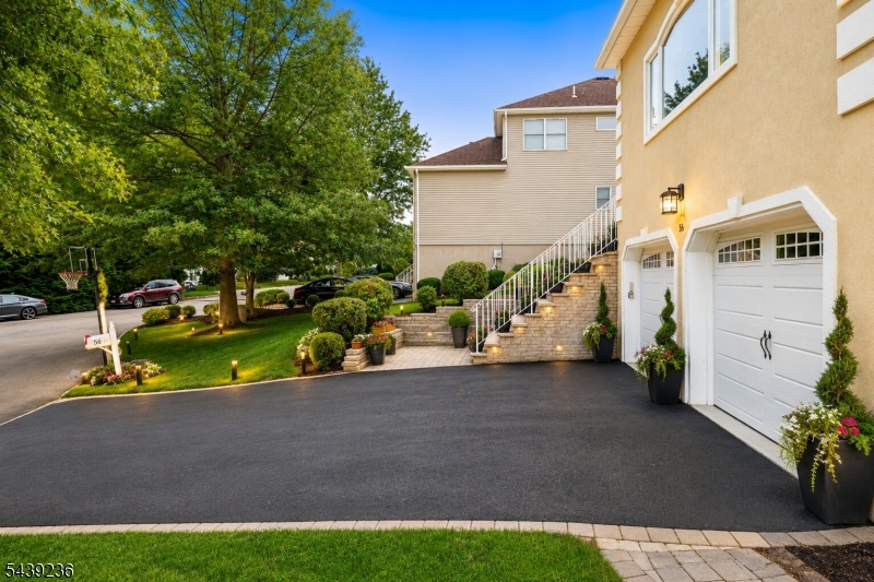 Welcome to this East facing Colonial home in Morris Plains' most desirable neighborhoods. Backing directly to acres of preserved township reserve land, this extensively renovated home offers a lot. A two-story foyer with a custom stone accent wall, illuminated niche and updated flooring sets the tone. The open-concept layout features a welcoming kitchen that flows seamlessly into the spacious great room and family room with a wood-burning fireplace perfect for entertaining and everyday living.The luxurious primary suite offers two walk-in closets and a fully renovated (2022) spa-inspired bath with skylights and high-end finishes. Generously sized secondary bedrooms and updated bathrooms complete the upper level. Additional highlights include a fully finished walkout basement w/ custom wet bar area & powder room (2021) to total an approx 5,100 sq  ft of finished living space. 16.3-kW solar panel sys (2026  leased  for 25 yrs ), Dishwasher (2026) Water Heater (2020), (2026,), GAF roof with Golden Pledge Warranty (2022), Tesla fast charger (2023), new garage doors (2023), epoxy garage flooring (2025), sprinkler system (2025), upgraded HVAC systems, resurfaced driveway, and numerous upgrades throughout. Outside, enjoy a tastefully done custom-built approx 1500 sqft patio (2024) w/ granite bar countertop, dawn-to-dusk lights, sprinkler system, and powered shed.Conveniently located near major highways, NJ Transit, shopping, dining, parks, and top Morris County amenities.