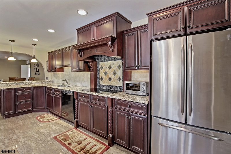 This stunning custom colonial boasts many features, just some of the finer highlights of this home included a first-floor master suite with hardwood floors, walk in closet and spa like full bath, a gourmet kitchen with endless granite counter and custom cabinet space, large center island, full size double wall ovens, breakfast bar & heated floors! The kitchen opens to the dining room and family room with stone fireplace and french doors to the entertainment size deck overlooking beautifully fenced in park like property with majestic sunset views. Located on a cul de sac street just minutes to Rt. 80 & 46, NYC commuter bus. and train makes this home a commuter?s dream! 5 minutes to downtown Hackettstown.