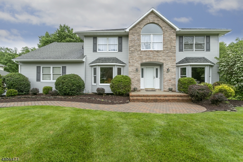 Perfection! Newer siding, picturesque manicured lot with a private setting backed by woods. Walk into the large foyer with custom molding. Large kitchen with breakfast island, natural gas oven with 5 burners, pantry, desk area - sliding glass doors to deck area. Family room boasts a gas fireplace with a marble hearth and custom mantle, plus recessed lighting. Living room and dining room have hardwood floors, bay windows & cornice moldings. Office on first floor could be a bedroom. 5 bedrooms on 2nd floor, plus 2 new baths. Master suite bath has a vaulted ceiling with skylight, jetted tub & stall shower. 5th bedroom has recessed lighting and 2 skylights!. Finished basement with 18 recessed lights, wall to wall carpet plus a full bathroom. To show this home, situated on a dead end street is to sell it.