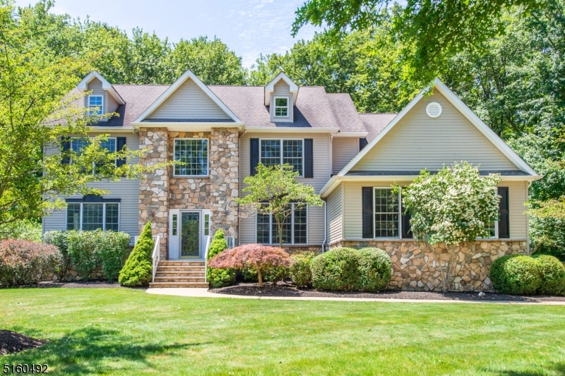 Stunning move-in ready four bedroom, two and a half bath colonial. The two story foyer showcases the staircase and leads to the formal living room on one side and the dining room with butlers pantry connecting to the kitchen on the other. The great room offers a gas fireplace, cathedral ceilings, tons of natural light and opens to the kitchen. The large kitchen with center island has a pantry, stainless steel appliances and granite countertops as well as a second staircase leading upstairs to the primary suite. A spacious office as well as powder room complete the main level. Upstairs is a primary suite with two walk-in closets and en-suite bathroom with a jetted tub, stall shower and double vanity. The floor is completed by 3 additional bedrooms all with spacious closets and a full bath. The three-car garage leads into the mud room / laundry room. Sliding doors from the kitchen lead to the large deck overlooking the flat and fully fenced-in backyard. Privacy abounds as the property backs to the woods and backs to Flanders Valley Golf Course. The huge unfinished basement offers a ton of storage and could easily be finished.