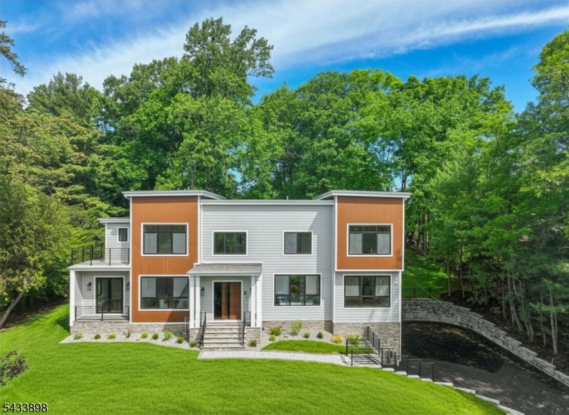 Be prepared to fall in love with this 6286 sq ft custom built 6 bedroom, 5 full & 1 half bath Contemporary Colonial located on over half an acre in one of the town's most desirable locations. Has 10' high ceilings, great natural light & an open floor plan designed for both daily living & elevated entertaining. Stunning Eat-in Kitchen features custom cabinetry, quartz countertops & professional-grade stainless steel appliances, centered around a generous island; the kitchen is totally open to a spectacular 2-story family room with gas fireplace, the ideal open floor plan. The first floor also features a private and convenient bedroom suite, a bonus room/den and gorgeous home office with terrific natural light. Upstairs, the second level is both expansive and intimate. 4 oversized bedrooms offer comfort and proportion, including a luxurious primary suite designed as a true retreat, featuring a spa-like bath with soaking tub & shower. 1 other bedroom enjoys its own en-suite bath, while two others share a bath. There is a 2nd level laundry room for added convenience. The beautifully finished lower level features soaring 9-foot ceilings, a huge recreation room, exercise room or guest bedroom with window, complete with a beautiful full bath & 3 car garage. This spectacular home, which features a gorgeous backyard with great privacy, is in an ideal location on a quiet street. Schools are highly rated! Livingston High is ranked #1 in Essex County in 2026!