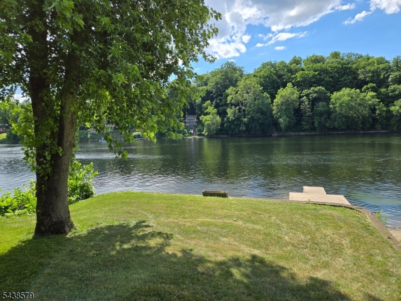 Lake front dream!  Spectacular location, jaw dropping views, LEVEL property!  Raised 2 story Cape Cod, with cathedral ceilings, skylights, wood flooring, sliding glass door leading to a deck, overlooking the river.  Master bedroom with a walk in cedar closet, loft was used as a 3rd bedroom with 2 closets and eve storage. Potential to finish the 1st floor huge unfinished room with windows, and sliding glass doors leading to a deck.  Huge ground floor basement offers a bathroom (not hooked up) garage door facing the river once opened faces the river with built in bar for parties.  Large concrete patio level backyard, complete with park bench and dock.  Perfect full time home or vacation home.  Endless possibilities!!  Needs TLC.  Estate sale, sold as-is. Flood insurance required. 2 lots across the street included,  Block 6 lot 16.01 and block 6 lot 25.  Also flood area.