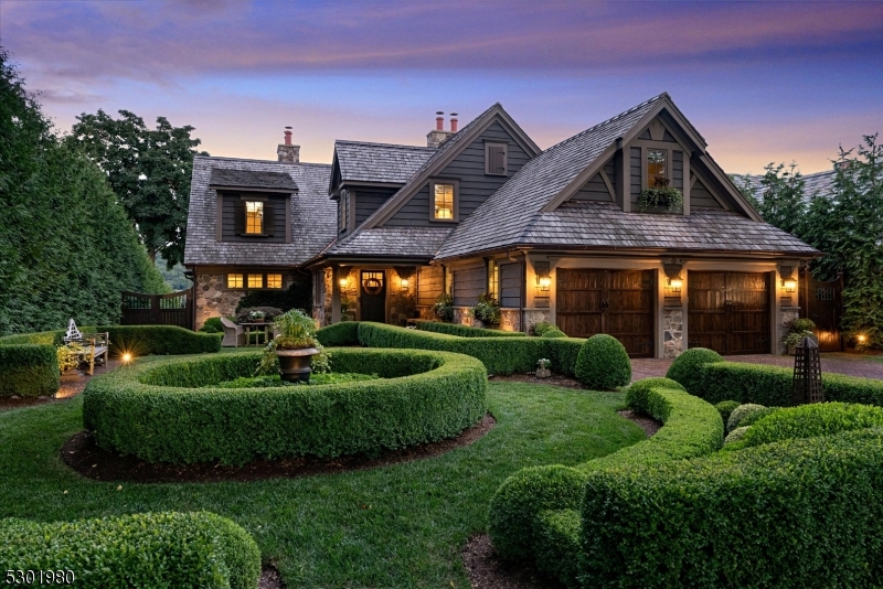 Lake Mohawk - Manitou Island English Inspired lakefront with manicured boxwood gardens and brick paths.  Completely renovated in 2018, 25 Island Trail blends timeless and tasteful design elements and all the necessary amenities needed to create a cohesive and inviting home.  Solid oak flooring, marble bathrooms, soaring ceilings, natural stone two story fireplace with reclaimed wood mantle, ceiling beams, custom lighting fixtures, designer window treatments and wallcoverings,  high end appliances, custom cabinetry and natural stone countertops throughout.  First floor primary suite offers a serene retreat, with french doors leading to deck, and a luxurious ensuite bathroom with custom cabinetry, marble tiles, and an oppulent dressing room and closet. New mechanicals, windows and doors. All NEW exterior features are:  cedar roof, cedar siding, composite decking (including 50' deck with pergola), 44' bluestone covered patio, stone retaining walls, irrigation system, landscape lighting, extensive landscaping, brick driveway and front walk and infinity edge gunite spa with waterfall.  Boathouse with new sun deck.  Renovations and system upgrades on file.  Enjoy all the amenities Lake Mohawk has to offer all year round! Boating, fishing, swimming, water sports, and private dining.  Experience the ultimate lakeside lifestyle at 25 Island Trail...just 50 minutes from NYC.