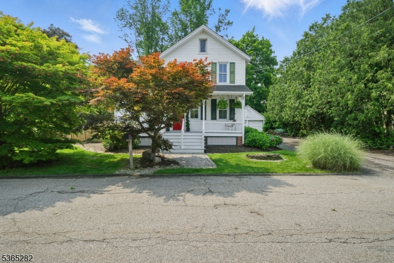 Picture Perfect! Old world charm updated with modern amenities. Craftsmen details from the crown molding down to the hardwood floors. This vintage beauty is NOT in a flood zone. Hurry - Won't Last! Covered lemonade, wrap around front porch living on a quiet cul-de-sac. Huge, backyard with updated outdoor seasonal use shower, perennial gardens, and brick paver patio. Backdoor to the mudroom. Stunning full bath with stall shower. Gorgeous gold details, Practicality and purpose throughout. Open living and dining area floor plan with pretty detailed staircase with beadboard. Built-Ins, French Doors, Hardwood Floors. Updated eat-In-Kitchen that boasts a center island, breakfast bar, and a 6 burner stove top gas stove. Three nice sized bedrooms with ceiling fans, built-ins, walk-in closet and hardwood floors. Primary suite boasts a shared jack n jill bath. Tons of storage in unfinished bsmt. Detached garage functions well as storage space. Walking distance from NYC-Direct train station, shopping & parks. Enjoy bustling Dwtn Denville or choose to visit historic Mt Tabor w/all its colorful homes, post office, library & LIVE events. Top schools. Special home and property! Underground oil tank just removed.