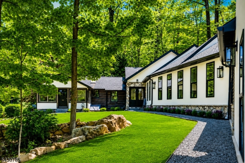For those seeking the finest in lakefront living, this Lake Mohawk retreat delivers. Set on over an acre with water views, the property includes an oversized 3-car garage with an unfinished loft large enough for pickleball or a private guest suite. With room for a Boat, RV, work vehicles, and every luxury toy, this home elevates lake life. Just minutes from white Deer Plaza, the residence blends classic charm with modern upgrades. completely transformed with top-quality construction and exceptional attention to detail, it must be seen to be fully appreciated. A manicured entrance leads to a welcoming foyer and an open-concept great room with a wood-burning fireplace and walkout to the private backyard. The main level features a chef's kitchen with butler's pantry, stainless steel appliances, and laundry. The first-floor primary suite offers a walk-in shower and his-and-her closets. An office, three additional bedrooms, and a cozy family room complete the main level. Major upgrades include a new roof, two new AC systems, and a newer boiler and hot water heater. A full list of improvements is available in the media section. Truly move-in ready. (3-bedroom Septic verified).