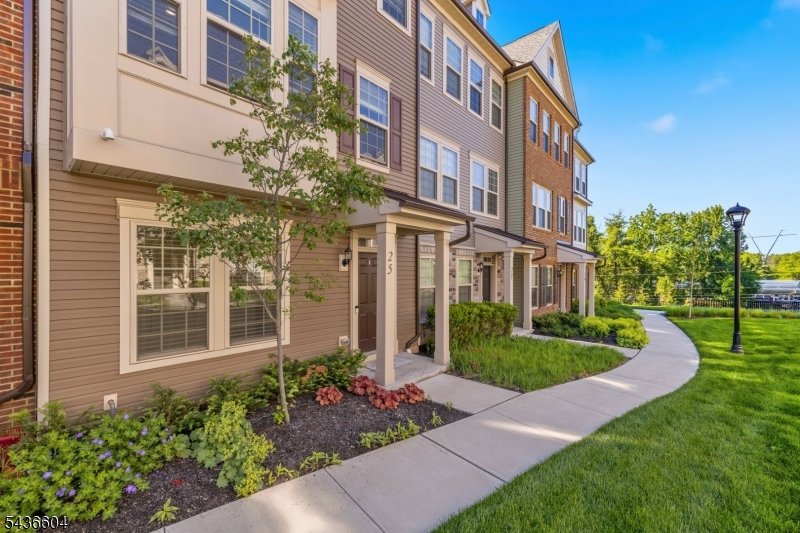 Luxury & convenience come together in this newest constructed townhome (2022) at Livingston Square, very low monthly HOA  ($238). It offers 4 beds, 3.1 baths, 2-car attached garage & professional upgrades throughout. Ground level features a foyer, a bedroom, a full bath with a built-in shower bench, coat closet, utility room & 2-car garage. Main level showcases an open-concept floor plan for both comfortable daily living & entertaining. It includes living room, dining room, gourmet kitchen & powder room. Kitchen features a large center island, quartz countertops, backsplash, S.S. appliances, newer high-performance vent hood vented to the exterior, newer Samsung Bespoke refrigerator, kitchen water filtration system & a large pantry. Balcony is off the kitchen. Upper level offers 3 bedrooms, a hall bath, linen closet & laundry room with newer LG Smart washer & dryer. Owner's suite features two walk-in closets & private bathroom with a double-sink vanity. Additional upgrades include wood flooring throughout, crown molding, customized closets, garage storage racks, owned water softener system, ceiling fans with lights in every room & high ceilings. Livingston is renowned for its excellent school system. Hassle-free commuting options include Coach USA bus to NYC & a free shuttle to S. Orange Train Station, both just across the street. Shopping, restaurants & medical facilities are all nearby. Move right in and enjoy the premium lifestyle & convenience that Livingston has to offer.