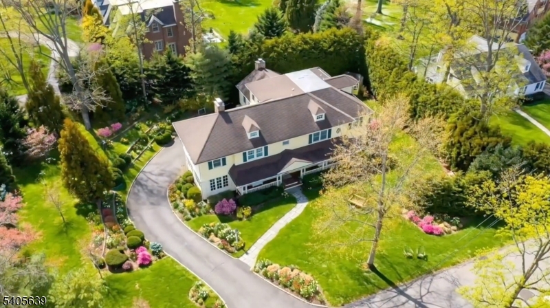 One of kind magazine worthy Colonial, ideally located on .59 acres of property with huge mature hedges for privacy and exquisite gardens on most prestigious street in Short Hills, walking distance to Hartshorn Elementary School, offering privacy and open floor plan with high end & custom finishes. Breathtaking home features grand 2 story entry with Living Room with beamed ceiling and wood-burning fireplace, Library with floor to ceiling windows, elegant Dining room perfect for entertaining with butler's pantry and French doors to Den/Sunroom with floor to ceiling windows, stunning new gourmet eat-in Kitchen with top of the line Subzero refrigerator / freezer,  Dacor 6 burner gas range and dishwasher appliances, 2 center islands & breakfast bar with separate breakfast area, totally open to Family room with wood-burning fireplace, wainscoting on vaulted ceiling, French doors open to beautiful deck with portico and gorgeous property. 2nd level features luxurious Primary Suite with walk-in closets, gas fireplace & dressing area. 2 new 5 star spa-like Primary Baths with soaking tub, stall shower & Toto washlet. 4 additional bedrooms with ample closets & two additional bathrooms. Beautifully finished Lower level with recreation room/media room, kitchenette with refrigerator, dishwasher and microwave, and bedroom, full bath, exercise room, jaw dropping 2,500 capacity temperature controlled wine cellar & access to 3 car garage. Enjoy the ultimate Short Hills lifestyle!! Low Taxes!!