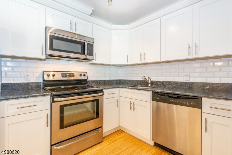 Bright, sunny and well maintained end unit. Freshly painted & newly installed cooling/heating system! Lovely 2 bedroom / 2 full bathroom with granite counter tops, breakfast bar and S/S appliances. Washer & dryer inside of the unit. Wood flooring in LR & DR. Secure elevator building with intercom. Storage space on the ground level. There is a covered parking space allocated but not specifically assigned with additional parking available. Walking distance to Morristown downtown shops, restaurants and bars.