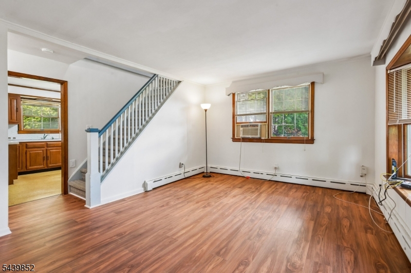 A beautiful move-in ready Cape Cod on a corner lot in a quiet neighborhood. Freshly painted with stainless steel appliances, new plumbing, and renovated baths. This 3-bedroom home features a spacious top-floor primary bedroom with its own half bath and private rooftop deck. The bright four-season sunroom overlooks a large, fully fenced backyard and stone patio. Additional features include an attached garage and a finished basement rec room with a large bar area and seating. Not in a flood zone.