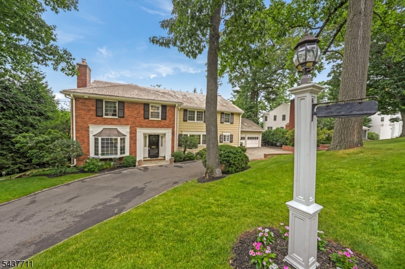 CROWN JEWEL WITH PALATIAL POOL! 18 Kings Hill Court is a magnificent 6-Bedroom, 4.2-Bath Center Hall Colonial that enchants with warmth and grandeur. Radiant Entry Foyer is vast yet inviting, and beckons your eye to the refined hardwood floors and thoughtful design that set an exquisite tone. French Doors escort you through spacious rooms, starting in Living Room, brilliant with bay window and majestic marble fireplace. Adjacent, expansive Family Room stuns with custom cabinetry and shelving on 3 walls, including Kitchenette and media center; as well as wall of windows overlooking fabulous fenced-in Backyard surrounded by lush greenery. Chef's Eat-In Kitchen shines with high-end appliances, center island w/ seating for 4, and immense glass slider to dazzling deck, a breathtaking setting for open-air dining and gatherings of all sizes. Perform at your peak in distinguished Home Office with bespoke wraparound desk. Powder Room and Laundry Room complete Level 1. Upstairs, five generous bedrooms, 2 of which with ensuite baths, including stunning Primary Suite with fireplace, sweeping property views, and 2 walk-in closets. Head down to the finished, enormous Lower Level for play, exercise, and/or entertaining, including two rooms with kitchenettes (countertops, cabinetry, sinks, and electric), before stepping out for a dip in gorgeous in-ground pool with hot tub. Check-out Summit's downtown for excellent dining; plus top-rated schools, and direct NY train. Your story starts here!