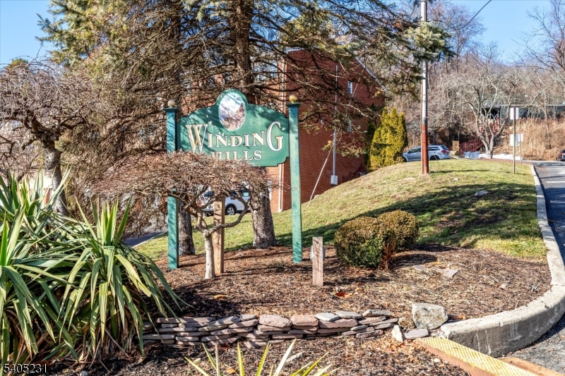 Updated second-floor 1-bedroom, 1-bath condo in the Winding Hills Condominium complex. Located at the top of the mountain, this unit offers a peaceful setting with access to walking trails throughout the community to enjoy the scenic lake views and woods. The 700 SqFt condo includes a galley kitchen with marble counter tops and and stainless steel appliances, dining area, spacious living room, bedroom with a retractable motorized projector TV screen, full bathroom with stand up shower and plenty of closets. Features include a large private storage unit and shared laundry in the basement of the F building, unassigned parking spaces and a pet-friendly complex.