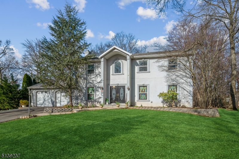 This is the home you've been waiting for! From the moment you walk in you will be impressed by all this home has to offer. The center hall foyer is flanked by a cozy formal living room with a wood-burning fireplace and a large dining room which fits an over-sized table. The back of the downstairs has an extra large family room and an incredible kitchen that features two dishwashers, two sinks, six-burner Viking stove, wine fridge, an oversized refrigerator and an entire wall of storage. Upstairs, be prepared to be blown away by a master suite that will not disappoint: huge walk-in closet, massive jetted tub for two, french doors leading to a balcony overlooking the backyard, gas fireplace, and a vaulted ceiling with skylights to bathe the room in natural light. Second bedroom also has a full bathroom and walk-in closet. Three additional bedrooms are all generously sized. And as if that isn't enough, the basement has a huge finished room ready for your exercise equipment, home theater plans, or just a massive playroom. Backyard is a gardener's dream, complete with concrete patio, deck, established gardens with a greenhouse, a water feature, and hot tub (AS IS). This is luxury. Close proximity to major highways, including 10, 287, and 80. Novartis campus is two blocks away. Don't miss this one - it won't last.