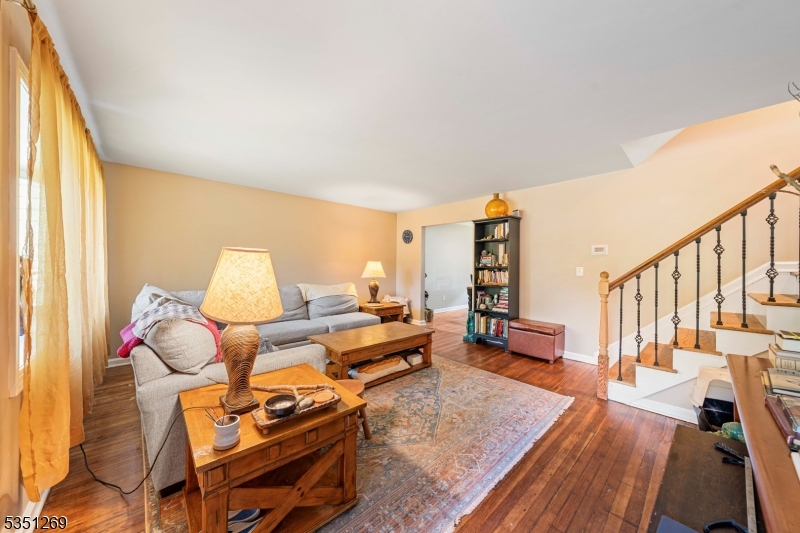 Move-in ready split-level home in the desirable Sunnyside section of Linden! The ground floor welcomes you with a bright living room with hardwood floors and an updated kitchen featuring a center island, ample cabinetry, and space for a cozy breakfast table. Off the kitchen, you'll find a versatile den perfect for a home office, playroom, or creative space with direct access to the attached garage and an unfinished basement offering plenty of storage. The second floor includes two comfortable bedrooms and a full bath, while the third level offers a spacious additional bedroom, ideal for a primary suite or guest room. Central AC and heating for convenience. Solar panel for energy efficiency. Enjoy a great-sized, fenced-in yard perfect for outdoor entertaining. Conveniently located near shops with easy access to the Garden State Parkway and major highways. A great layout with endless potential don't miss this opportunity!