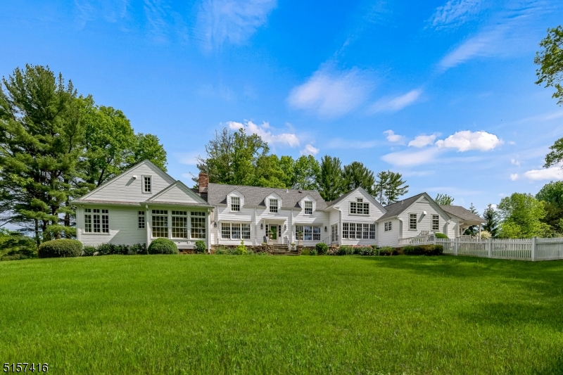 A coveted location in beautiful Bedminster Township, Tall Oaks Farm presents the comfortable warmth of years past coupled with the modern amenities of today. Enjoy the breath-taking views of the expansive tree-lined driveway as you come upon this beautifully maintained classic farmhouse sitting on 15.2 acres of private land. Original hand-hewn beamed ceilings adorn the library, dining and living rooms while the kitchen opens to a generous family room with vaulted ceiling, fieldstone gas fireplace and nearby screened-in porch. A first-floor primary suite includes walk-in closets, a gorgeous updated bathroom with heated floors and a sunroom just around the corner. Plenty of space upstairs with four sizable bedrooms and three full baths, including a bedroom suite with full bath and spacious closets. The carriage house is a short walk away with 1,200 sqft of living space including an open space kitchen and family room with high ceilings, two large bedrooms, 1.1 baths and a four-car garage underneath. The inviting in-ground pool and pool house sit quietly off the west side of the home for relaxing or entertaining while the converted sheep barn with concrete floors, heating and electric serves as an excellent workshop.