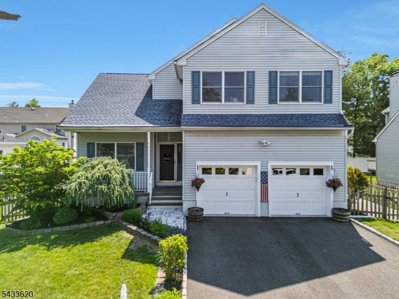 Welcome Home!  This beautifully maintained 4-bedroom, 2.5-bath Colonial offers a bright, functional layout and great indoor-outdoor living. The main level features a welcoming foyer, formal living and dining rooms, a comfortable family room, and an spacious eat-in kitchen with stainless steel appliances, white cabinetry, tile backsplash, and ample counter space. A convenient laundry room and powder room complete the first floor.  Upstairs, the spacious primary suite includes a walk-in closet and private bath with soaking tub, separate shower, double vanity, and skylight. Three additional bedrooms and a full bath provide plenty of flexible space. Enjoy outdoor entertaining on the rear deck overlooking a beautifully landscaped, fenced backyard with paver patio, fire pit area, and mature greenery. Additional highlights include a 2-car garage, charming front porch, and great curb appeal. A wonderful home with space, comfort, and inviting outdoor amenities.  New furnace and hot water heater; roof is 8 years old.