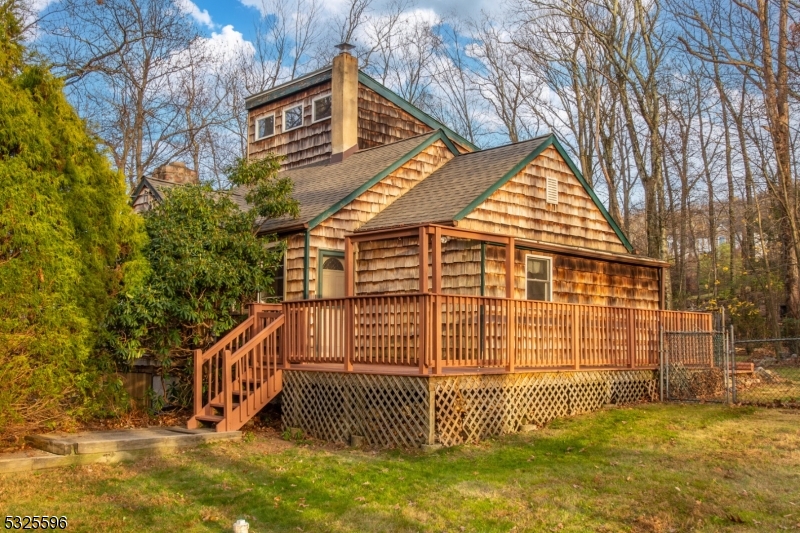 Welcome to this Beautifully maintained home located on the picturesque Green Pond Road in desirable Rockaway Township with an Absolutely MASSIVE Fully Fenced-In Flat Backyard! This charming residence offers the perfect blend of comfort, convenience, and natural beauty, with easy access to local amenities, top-rated schools, and major highways. Step inside and discover a spacious and inviting layout, featuring a bright Living Room with cozy wood-burning Fireplace with detachable electric Fireplace insert, and large windows that allow natural light to fill the space. The kitchen boasts modern appliances, ample cabinet space, and a cozy dining area ideal for gatherings or entertaining guests. The home includes 2 generously sized bedrooms including a BONUS ROOM that can easily be used as a 3RD Bedroom, Office, Nursery, Exercise or Flex Room, each offering plenty of closet space and room to relax. The Primary suite provides high Vaulted Ceilings complete with an En-Suite Bathroom for added privacy and convenience. The Backyard Oasis features a private Deck, Huge level yard space, and Dog Run allowing endless possibilities for your design & creativity. Do not miss the opportunity to own your Dream Home!