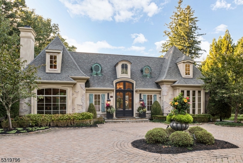 Welcome to 274 Woodside Avenue, an extraordinary 8,800 sq ft luxury estate in Franklin Lakes, NJ. This meticulously designed home offers sophisticated craftsmanship and modern comfort. A grand foyer with stone floors leads to a spacious living room filled with natural light, a formal dining room, and a custom butler's pantry. The gourmet eat-in kitchen features two islands, premium appliances, and flows into a sun-filled family room with French doors to the outdoor retreat, complete with a kitchen, fireplace, and lounge area. The primary suite includes dual walk-in closets and a spa-like bath. The finished lower level offers a wine room, bar, and media area. Additional highlights include a first-floor suite, 3-car heated garage, and whole-house generator.
