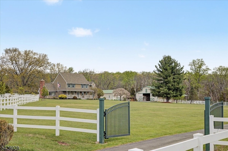 Exceptional equestrian property set on nearly 10 acres in one of Hunterdon County's most sought-after locations. This turnkey offering features a well-maintained 4-bedroom Colonial with over 3,300 sq ft, a remodeled kitchen (2020), hardwood flooring, wood-burning and pellet stoves, and recent updates including a new roof (2025), new furnace (2026), and upgraded 200-amp electric service with generator hookup.The 38' x 60' barn includes 6 stalls (12x12), automatic waterers with individual consumption monitoring, interlocking rubber pavers in center aisle, tack room, feed room, wash stall, and hay area. Three stalls offer direct paddock access, with additional turnout via aisle. Outdoor features include multiple fenced paddocks, run-in sheds, a 70-ft round pen, and a 4-horse hot walker, and dog run. Equipment building provides additional storage. Property also features an inground pool, patio, and open pasture views. Ideally located just minutes to Alexandria Township indoor riding arena, with easy access to Bucks County Horse Park, local trails, and regional equestrian venues. Surrounded by preserved farmland. A rare opportunity to own a fully equipped horse property in a prime location.