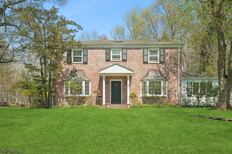 Tucked away on a quiet cul de sac in the highly desirable Deerfield section of Short Hills rests this 5 bedroom, 3 1/2 bath classic center hall Colonial. With 3 finished levels, this move in ready home is rooted in timeless design. Filled with natural light that highlights its elegant interiors, with gleaming hardwood floors throughout. The primary bedroom is spacious with generously sized closets and an en-suite bath, while 3 additional bedrooms sharing a hall bath complete the second floor. The main living space includes a grand & gracious living room with a fireplace, a dining room off the kitchen, a sunlit family room with skylights and a thoughtfully located first floor bedroom/home office adjacent to the powder room which is ideal for remote work or easily converted into an in-law suite. The finished lower level provides versatile space for recreation or a home gym. Set on a lush half acre lot surrounded by mature trees the property features a private bluestone patio perfect for relaxing or entertaining. Moments from top rated schools, parks and convenient access to NYC transportation
