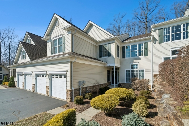 This beautifully maintained 3-bedroom, 3.1-bath residence with a 2-car garage offers refined living with thoughtful upgrades and exceptional space for entertaining. The foyer upon entry is greeted with hardwood floors and a stunning two-story living room and a formal dining room with tray ceiling and crown molding. The inviting great room with gas fireplace flows into the open kitchen featuring granite countertops, center island, and bright breakfast area with sliders to a composite deck perfect for relaxing or outdoor dining. A pellet grill (never used) is included. The main level also features a private den with custom cabinetry, ideal for a home office or reading retreat. Throughout the home you'll find custom draperies, tailored valances, and motorized blinds in the kitchen and primary bedroom. Upstairs offers three generously sized bedrooms. The primary suite features a sitting area and spa-inspired bath with heated floors, double sinks, soaking tub, and walk-in shower. The hall bath has been tastefully updated with double sinks and a modern walk-in shower. The finished waterproofed basement expands the home's lifestyle appeal with a wet bar, beverage refrigerator, recreation area, exercise room, and flexible entertaining space. Located in an active adult community, offering low-maintenance living close to shopping, dining, and major commuter routes. Meticulously maintained and truly move-in ready; schedule your showing today!