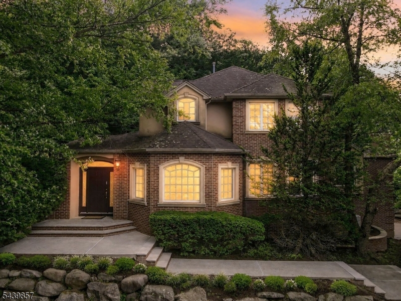 RARE OPPORTUNITY TO OWN A CUSTOM RINGWOOD COLONIAL W PRIVACY & PREMIUM CUL-DE-SAC LOCATION IN THE HIGHLY COVETED KENSINGTON WOOD SUBDIVISION. Sellers have made major improvements since last Nov to turn the property into a dream home - ready to host exquisite summer gatherings!  Set on a quiet cul-de-sac backing to parkland, this 4-bedroom, 3-bath home offers the kind of flexible layout today's buyers want: open gathering spaces, a main-level en-suite bedroom AND office, finished basement, 3-car garage, & peaceful natural backdrop. Granite kitchen w breakfast bar & pantry, bright dining/sitting area w backyard views, patio access, & gas fireplace. Spacious living room w second gas fireplace. First-floor BR w full en-suite bath for guests or extended household living.    Upstairs primary suite w skylights, soaking tub, stall shower, & double vanity. Two additional BR share a connected full bath. Bonus loft w flex space for an office, media lounge or homework zone. Finished basement adds valuable recreation space w wet bar & storage.    The best of Ringwood living: parkland setting, optional Skyline Lakes membership, minutes to Park & Ride w NJ Transit service to NYC.    Seller investments: professional HVAC/indoor air-quality remediation & cleaning, new primary BR & basement flooring, garage drywall & door refurbishment, & appliance upgrades. Whole-house generator, central air, patio, Skyline Lake rights option make this one of the strongest upper-tier values in Ringwood.