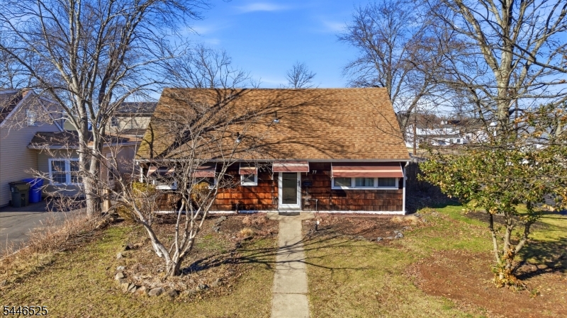 Move right into this beautifully maintained 4-bedroom Cape Cod on a prime corner lot with a side-entry 2-car garage, oversized driveway, and a private fenced backyard perfect for entertaining. The bright living room with crown molding, laminate floors, and picture window opens to a formal dining room with sliders to a wood deck and paver patio. The eat-in kitchen is well appointed with oak cabinetry, crown molding, recessed lighting, tile flooring, tile backsplash, gas 5-burner cooktop, wall oven, microwave, dishwasher, refrigerator, and outside-vented fan. Adjacent to the kitchen is a laundry area with an all in one washer/dryer. A spacious family room with high ceilings, built-ins, ceiling fan, and direct entry to the oversized garage w/additional attic w/pull downstairs and backyard access adds wonderful flexibility. The main level offers two bedrooms and a full bath, while the second floor features two additional bedrooms plus a large walk-in attic/storage area. An upstairs alcove with plumbing nearby offers great potential for a future second bath. Enjoy central air, gas heat, outdoor lighting, built-in storage shed, fire pit area, and newer fencing. Fantastic location close to Metropark train station (1.6 miles, all major highways -gsp, njtp, routes 1&9, shopping, and more.