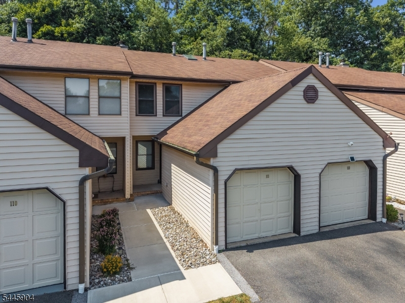 Discover this beautifully maintained 2 bedroom, 1.5 bath condo in the desirable Sun Ridge community of Raritan Township. Step inside and you're greeted by updated finishes, a prime location backing to woods and two skylight windows - a rare feature in this community!Enjoy a spacious living room featuring a wood-burning stone fireplace, luxurious laminate floors, & recessed lighting. The eat-in-kitchen boasts updated oak cabinetry with stainless steel appliances-dishwasher ('25) & stove ('22). A sliding glass door off the kitchen leads to a large deck backing to private woods - a prime location for outdoor enjoyment. Completing the first level is a recently updated powder room.Upstairs,find two generously sized bedrooms with large closets, brand new carpeting ('26) & ceiling fans. A large full bathroom completes this level. This unit offers a full basement with washer & dryer,new sump pump ('26). Key features include freshly painted throughout ('26),brand new carpeting ('26),updated hot water heater ('22),one car attached garage with new opener ('26), & newer windows.Sun Ridge offers fantastic amenities within walking distance: an in-ground pool, tennis & basketball courts, a soccer field, multiple playgrounds, & scenic walking/biking paths. Enjoy easy access to commuter routes, diverse shopping & dining, and the charming downtown of Flemington. Benefit from top-rated local schools. Your opportunity for stylish & easy living in the sought-after Sun Ridge community awaits!