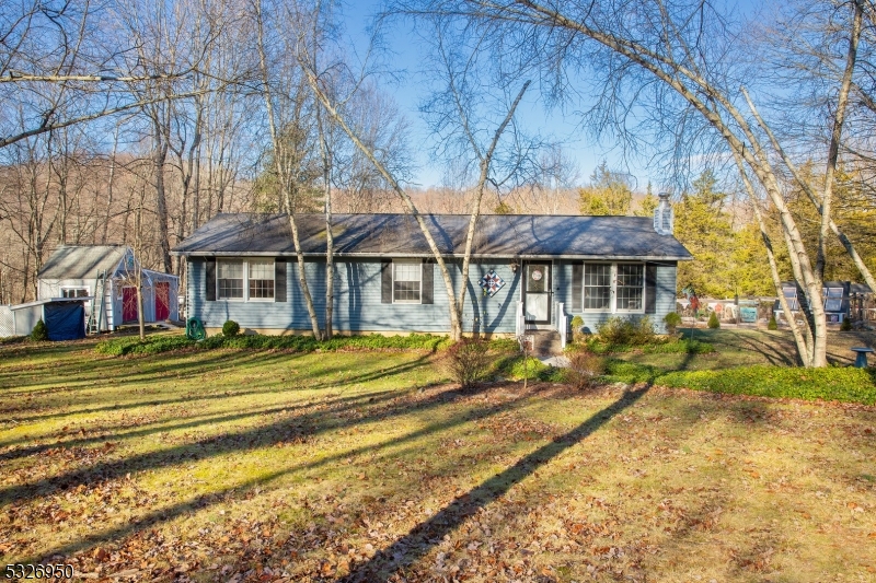 Get ready to experience serene country living in this charming 3-bedroom, 1-bathroom ranch nestled on 4.5 picturesque acres. The highlight is a backyard that is a true retreat, featuring a greenhouse for gardening enthusiasts, a dedicated canoe shed, and a versatile outbuilding equipped for maple syrup production. Continue to enjoy the outdoors w/custom built trail that encompasses the entire perimeter of the property. Wide vantage views from the comfort of your deck is ideal for entertaining or soaking in the peaceful surroundings. Step through the wood door with decorative panels into a rustic interior Living Room featuring a tongue and groove knotty pine wood ceiling. The Living Room opens into a newly updated Kitchen boasting TONS of storage with wood cabinets and quartz countertops with partial backsplash.  Dining area boasts breathtaking views of a true retreat. Craftsmanship is crawling throughout this home with a Laundry Room boasting custom built-in chairs for convenience of putting on shoes as you access the outside sprawling Trex Deck. Thoughtfully designed, the home features a beautifully crafted bathroom with heated floors for cozy mornings. Each of the three bedrooms features warm, welcoming colors, with one showcasing a stunning wood-stained pine accent wall that adds character and rustic charm. The fully finished basement offers versatile space. HIGHEST AND BEST OFFER TERMS DUE WEDNESDAY, DECEMBER 11TH BY 5:00pm PLEASE SUBMIT TO BOTH KATHI AND JENNIFER!