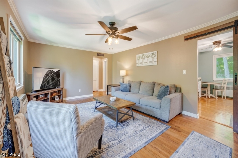 Beautifully updated and move-in ready 1-bedroom 2ne floor condo nestled in the picturesque, park-like setting of Troy Hills Village. This bright and inviting home features a spacious living room filled with natural light, hardwood floors, crown molding, and neutral decor throughout. The kitchen offers abundant white cabinetry, granite countertops, subway tile backsplash, stainless steel appliances, and a charming breakfast nook perfect for morning coffee or casual dining. The generously sized bedroom provides ample closet space and hardwood flooring, while the updated bath is tastefully finished in timeless neutral tones. Enjoy the beautifully maintained grounds, and the convenience of assigned parking. Community amenities include a large newly renovated swimming pool and expansive green space. Ideally located near Routes 22, 78, and the Garden State Parkway, with easy access to NYC-bound trains and buses, shopping, and dining. A wonderful opportunity to enjoy low-maintenance living in one of the area's most desirable communities. Dogs permitted per association guidelines.