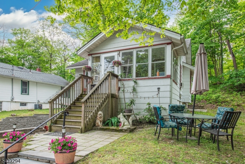 Charming opportunity in the heart of Newton! Situated on an oversized double lot, this 2-bedroom, 1-bath home offers a rare combination of in-town convenience and expansive outdoor space. Built in 1919, the property features original hardwood floors throughout, bonus attic space, enclosed porch, attached 1-car garage, and a spacious yard with endless possibilities for gardening, recreation, expansion, or future improvements.The home's manageable footprint makes it an ideal option for many buyers, downsizers, investors, or anyone looking to add their personal touch. Mature surroundings and a generous lot create a private setting while remaining close to shopping, dining, schools, parks, and major commuter routes.Bring your vision and unlock the potential of this unique property. A rare chance to own a large parcel within Newton with room to grow and customize.
