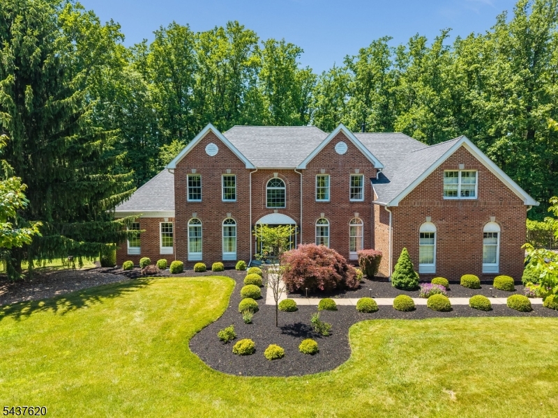 Welcome home to this Toll Brothers Monroe model on a quiet cul-de-sac in a highly sought-after neighborhood. Move-in ready & well maintained. Offering the perfect blend of elegance, comfort & privacy. Step outside to your own private resort-style backyard featuring a fenced in-ground pool, professionally landscaped & wooded views. Multi-level deck w/dual staircases & built-in stair lighting. Paver walkway leads to a lower-level patio. Inside, two-story foyer w/ a double-turned staircase, formal LR & DR flank the entry, sunny sunken GR w/ cathedral ceilings, custom built-ins. FR w/ vaulted ceiling & wood-burning fireplace. Spacious gourmet kitchen w/ center island, maple cabinetry, granite countertops, new appliances, pantry & breakfast area. Office w/ custom built-ins, powder room & mudroom/laundry room complete 1st level. Upstairs, 4 generously sized bedrooms all w/ updated bathrooms. Expansive primary suite features a private sitting area, dual walk-in closets, large bonus room & spa-like bath w/ vaulted ceiling, soaking tub, separate shower & dual vanities. En-suite bedroom & two bedrooms connected by a Jack-and-Jill bath. Walkout basement w/ endless potential w/direct access to the lower level patio.  Hardwood flooring throughout most of 1st level, new carpeting upstairs, newer roof (2021), updated HVAC systems (2015 & 2017), generator hookup & NO HOA. Conveniently located just minutes from Route 78 & NYC bus service in Clinton. Cameras outside the home.