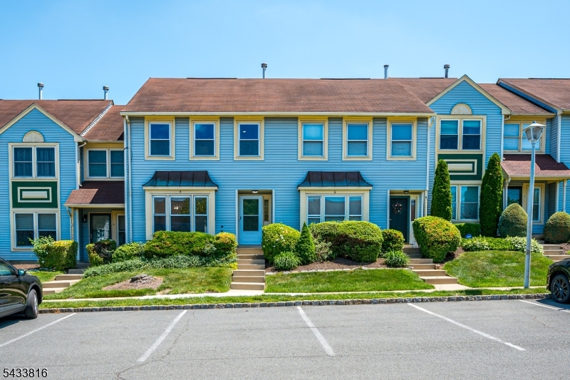 Beautifully appointed two-story townhome in a desirable Sayreville community, offering the perfect blend of comfort, style, and convenience. This spacious 2 bedroom, 2.5 bath residence features a thoughtfully designed layout offering hardwood floors, new carpet upstairs in the bedrooms, lovely tiled floor in the kitchen. Recessed lighting throughout, freshly painted and tasteful updates throughout.The kitchen showcases beautifully tiled floor, opens seamlessly to a private deck overlooking a lush green lawn. Ideal setting for morning coffee, outdoor dining, or peaceful summer evenings. The kitchen area is warmed by a charming woodburning fireplace, adding character and a cozy focal point for everyday living and entertaining.Upstairs, both generously sized bedrooms enjoy the convenience of their own full bath, creating comfort and privacy. The spacious primary suite overlooks the common lawn space in the back. Upgraded baths have been refreshed over time.Fantastic Community offering swimming pool, basketball court, and playground, this home also offers exceptional convenience to public transportation, Route 9, the NJ Turnpike, NYC access, and the Jersey coastline.Don't miss this one. It's really something worth looking at.